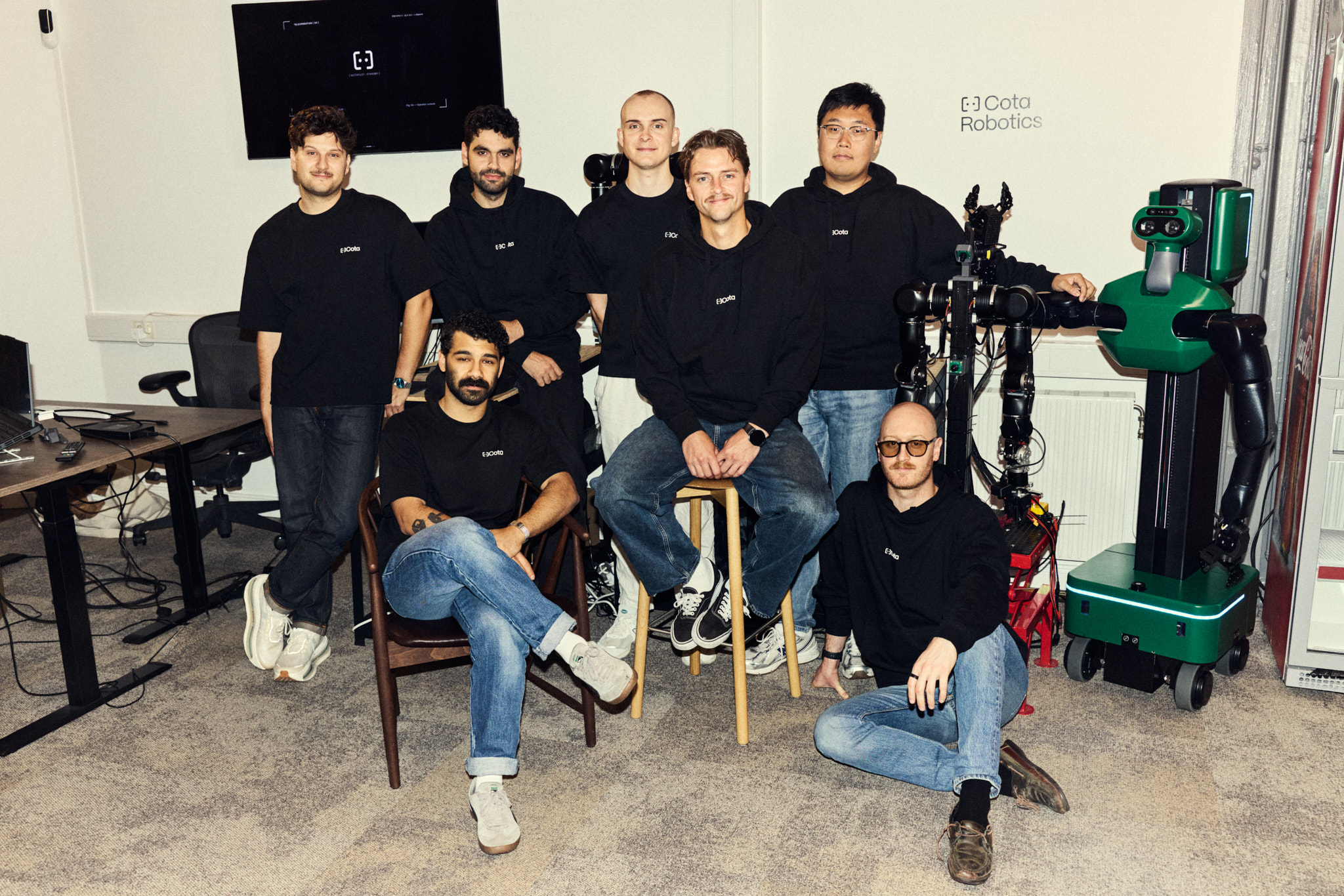 The Cota team with a robot in the Stockholm office